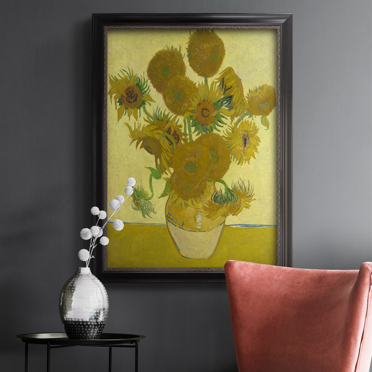 Impressionist sunflower still life painting by Vincent van Gogh in an ornate black frame with gilded inner detail displayed in a dark-toned interior setting.