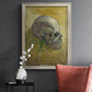Profile skull study artwork by Vincent van Gogh in an ornate champagne frame displayed in a dark-toned interior setting.