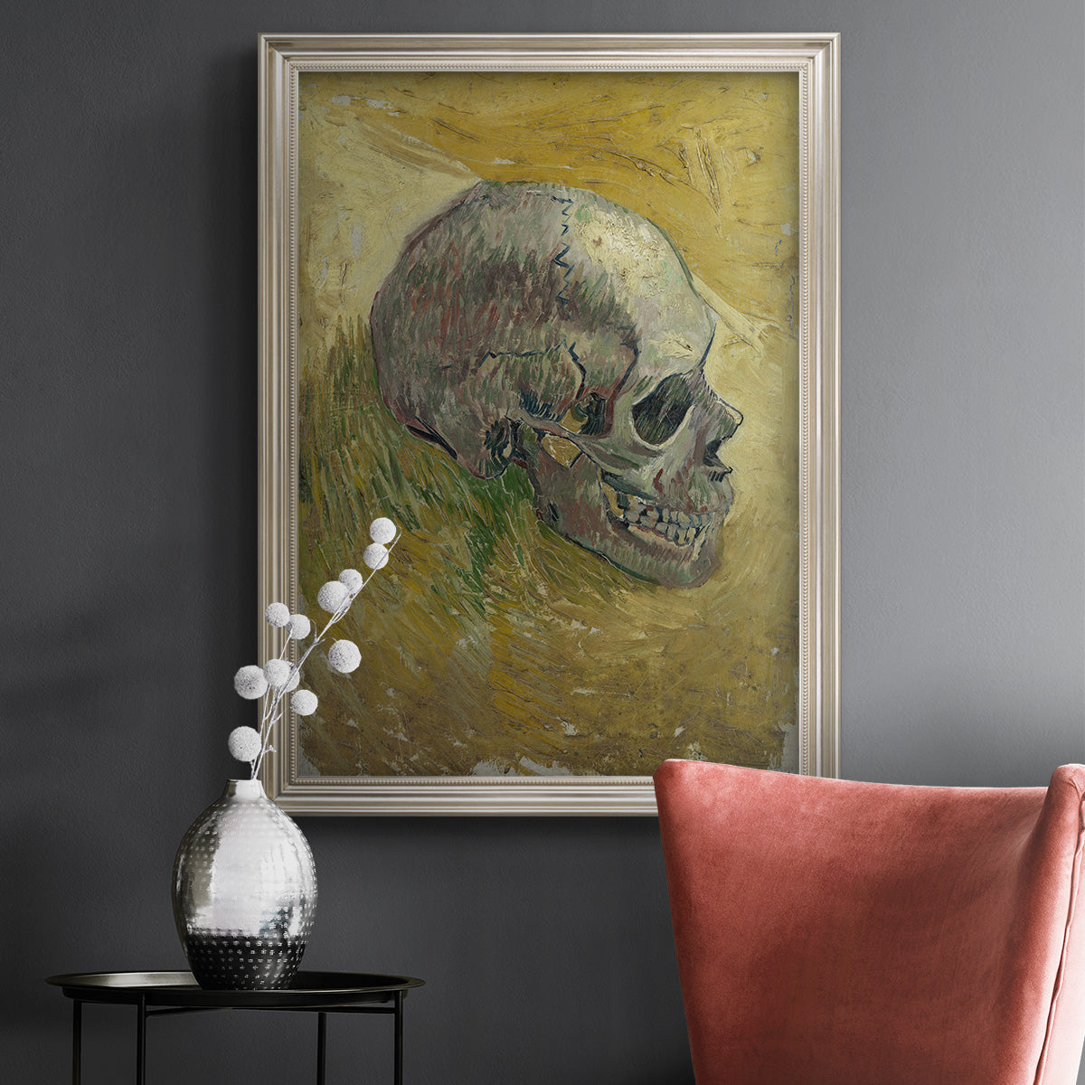 Profile skull study artwork by Vincent van Gogh in an ornate champagne frame displayed in a dark-toned interior setting.
