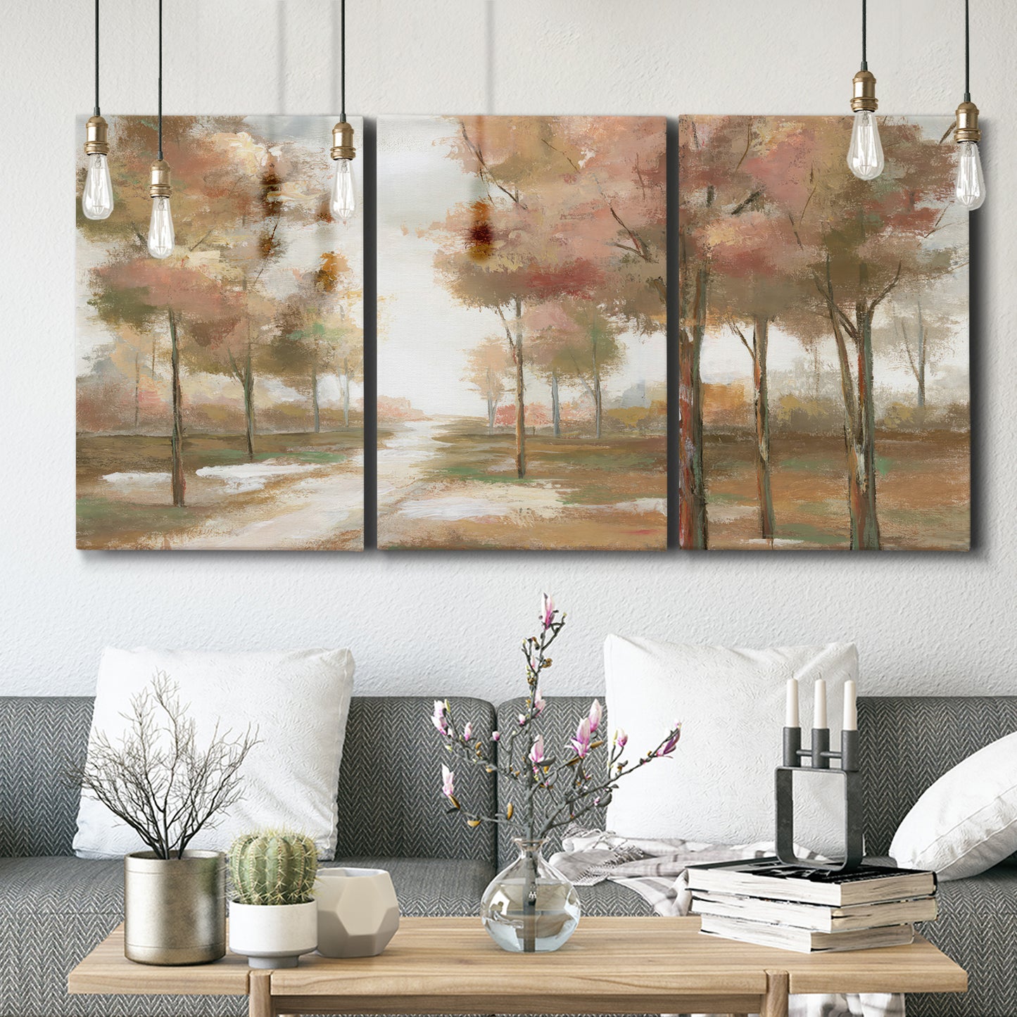 Three-panel canvas wall art featuring soft pastel park landscape scene, displayed in a modern living room above seating.