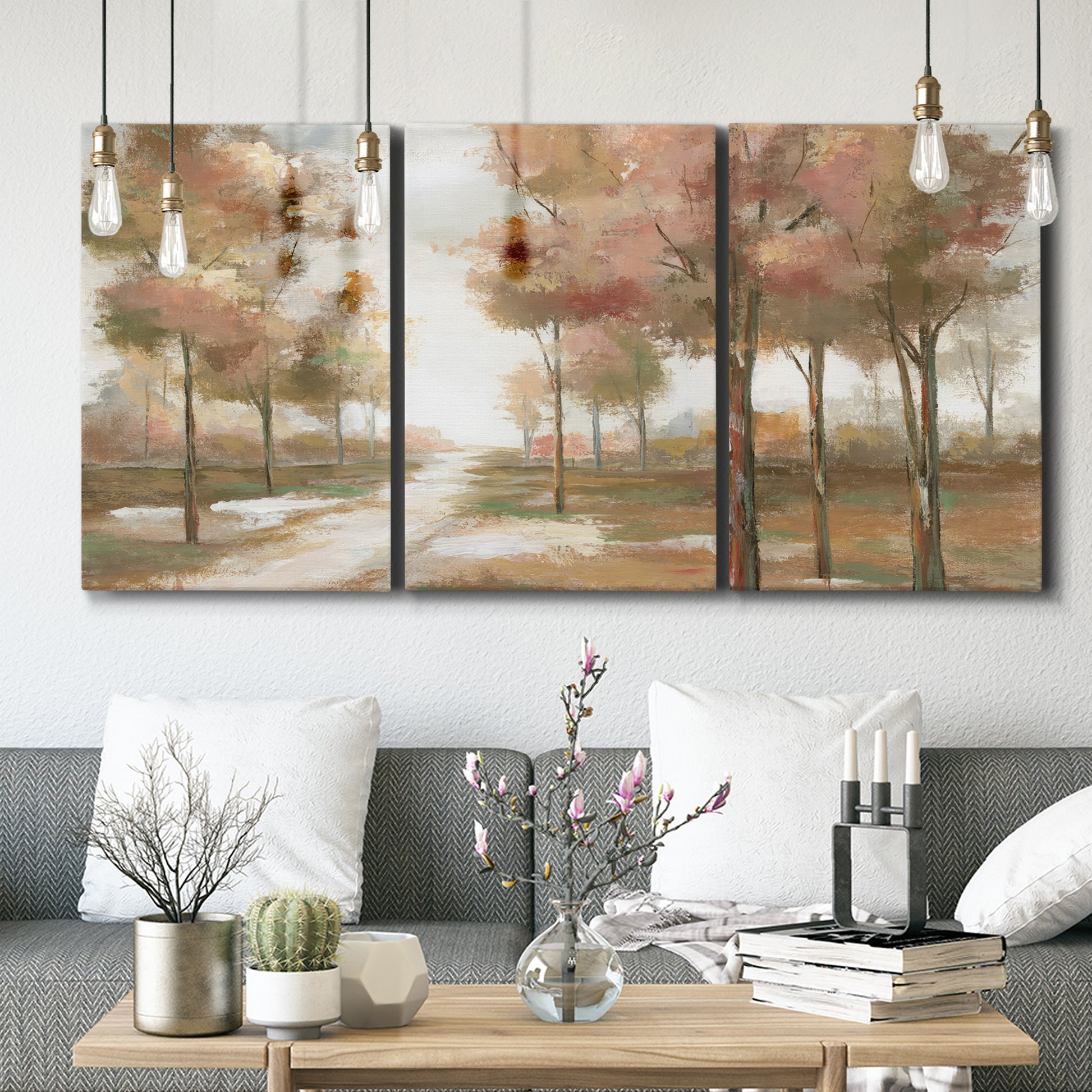 Three-panel canvas wall art featuring soft pastel park landscape scene, displayed in a modern living room above seating.