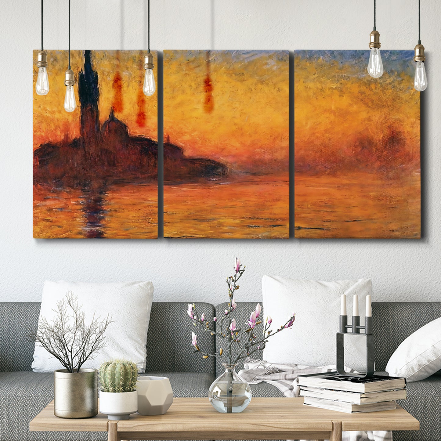 Three-panel canvas wall art featuring Venetian church at sunset, displayed in a modern living room above seating.