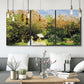 Three-panel canvas wall art featuring lush garden landscape with trees, displayed in a modern living room above seating.