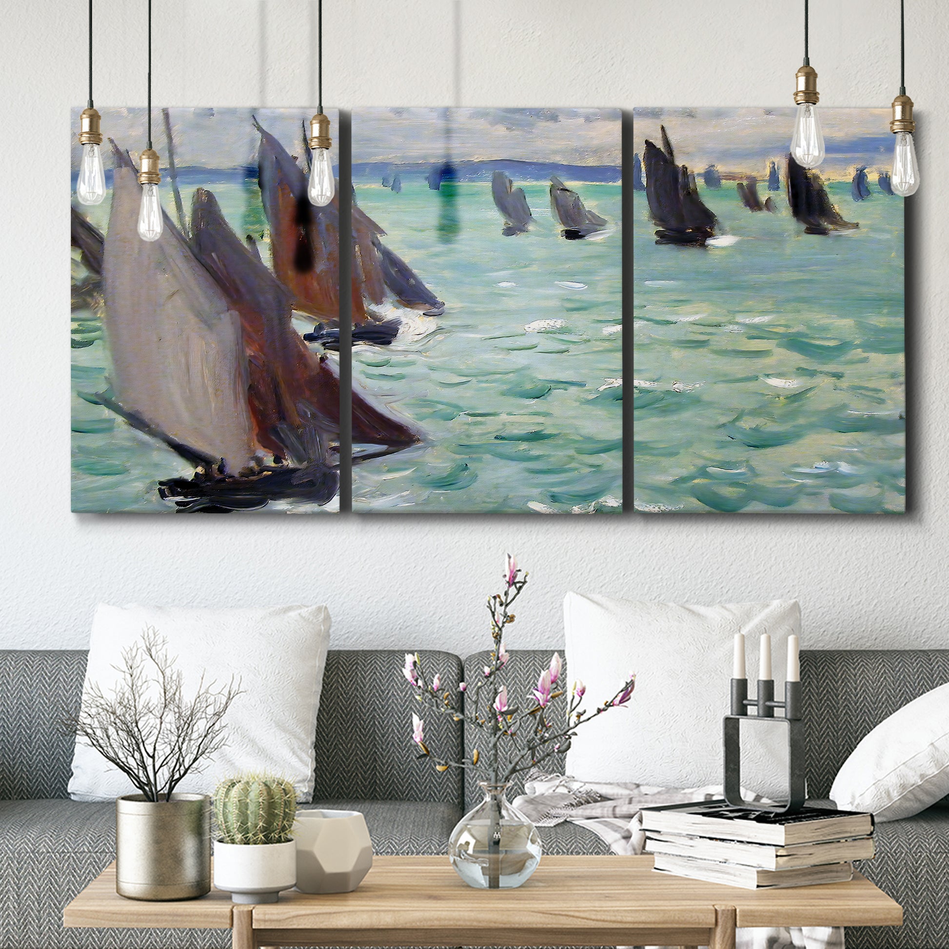 Three-panel canvas wall art featuring sailboat regatta near coastal village, displayed in a modern living room above seating.