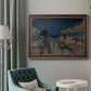 Impressionist nighttime Paris street scene by Camille Pissarro in an ornate bronzed mahogany wood frame displayed in a bright interior setting.