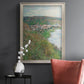 Impressionist landscape view of Vétheuil by Claude Monet in an ornate champagne frame displayed in a dark-toned interior setting.