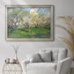 Impressionist spring orchard landscape by Vincent van Gogh in an ornate champagne frame displayed in a bright interior setting.