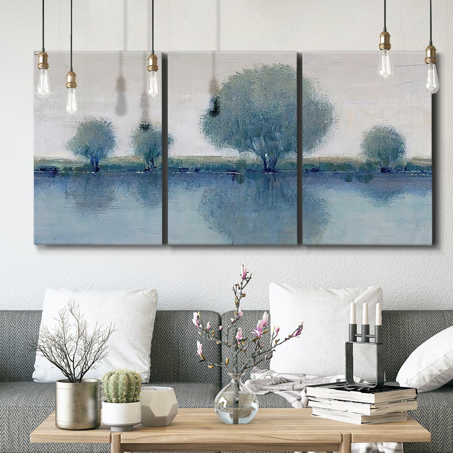 Three-panel canvas wall art featuring calm afternoon river reflection, displayed in a modern living room above seating.