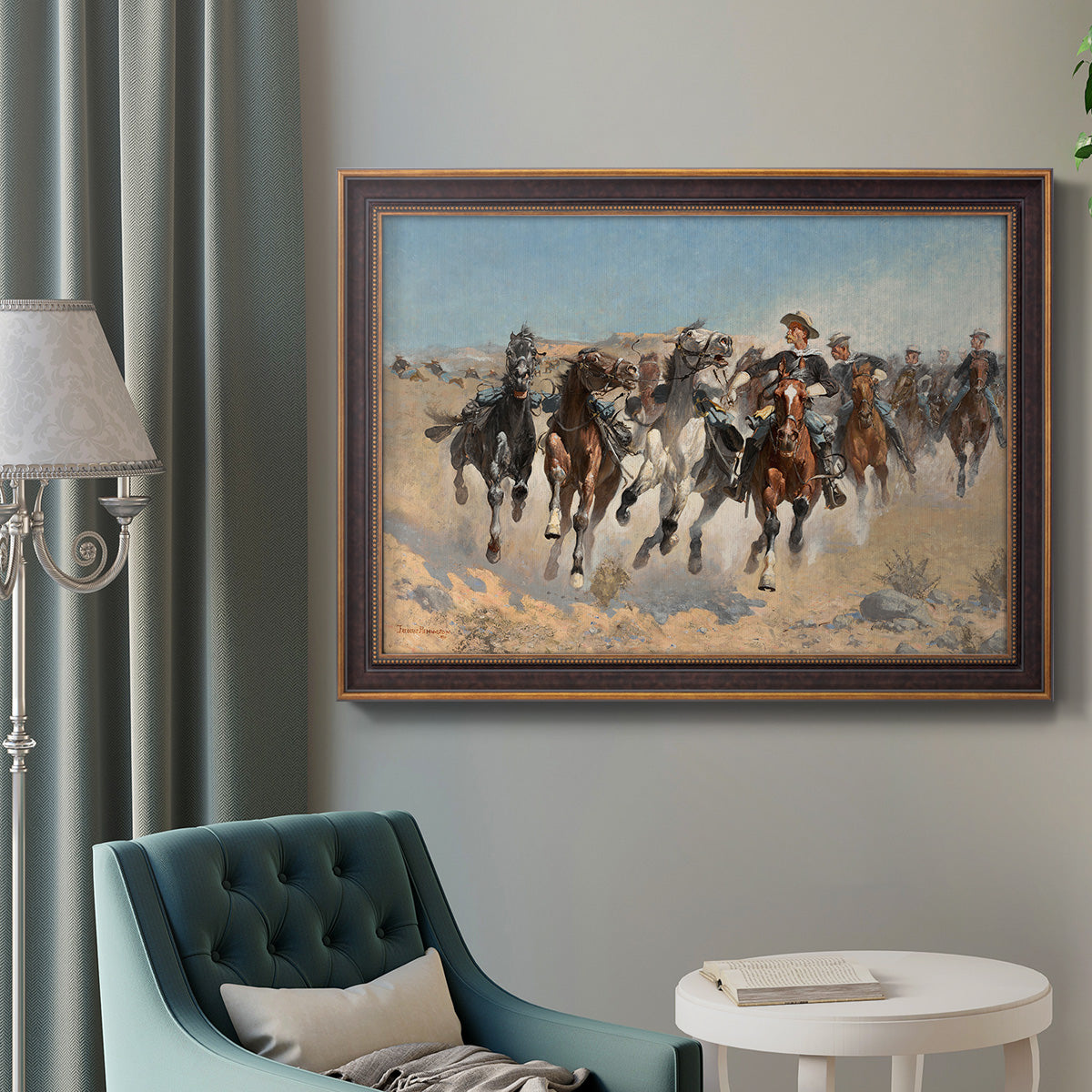 Impressionist western action scene by Frederic Remington in an ornate bronzed mahogany wood frame displayed in a bright interior setting.
