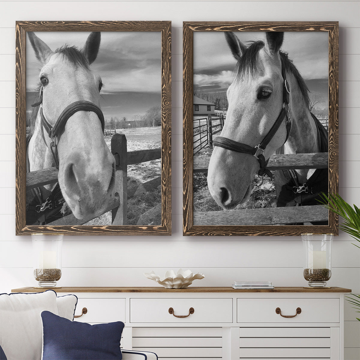 Set of two walnut barnwood framed canvas prints depicting a coordinated art pair of black-and-white close-up portraits of horses at fences rendered as modern equestrian photography above a dining room sideboard.