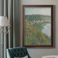 Impressionist landscape view of Vétheuil by Claude Monet in an ornate bronzed mahogany wood frame displayed in a dark-toned interior setting.