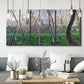 Three-panel canvas wall art featuring spring landscape along river, displayed in a modern living room above seating.