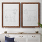 Set of two maple barnwood framed canvas prints depicting a coordinated art pair of simple contour drawings of standing cows rendered as minimalist livestock sketches above a dining room sideboard.