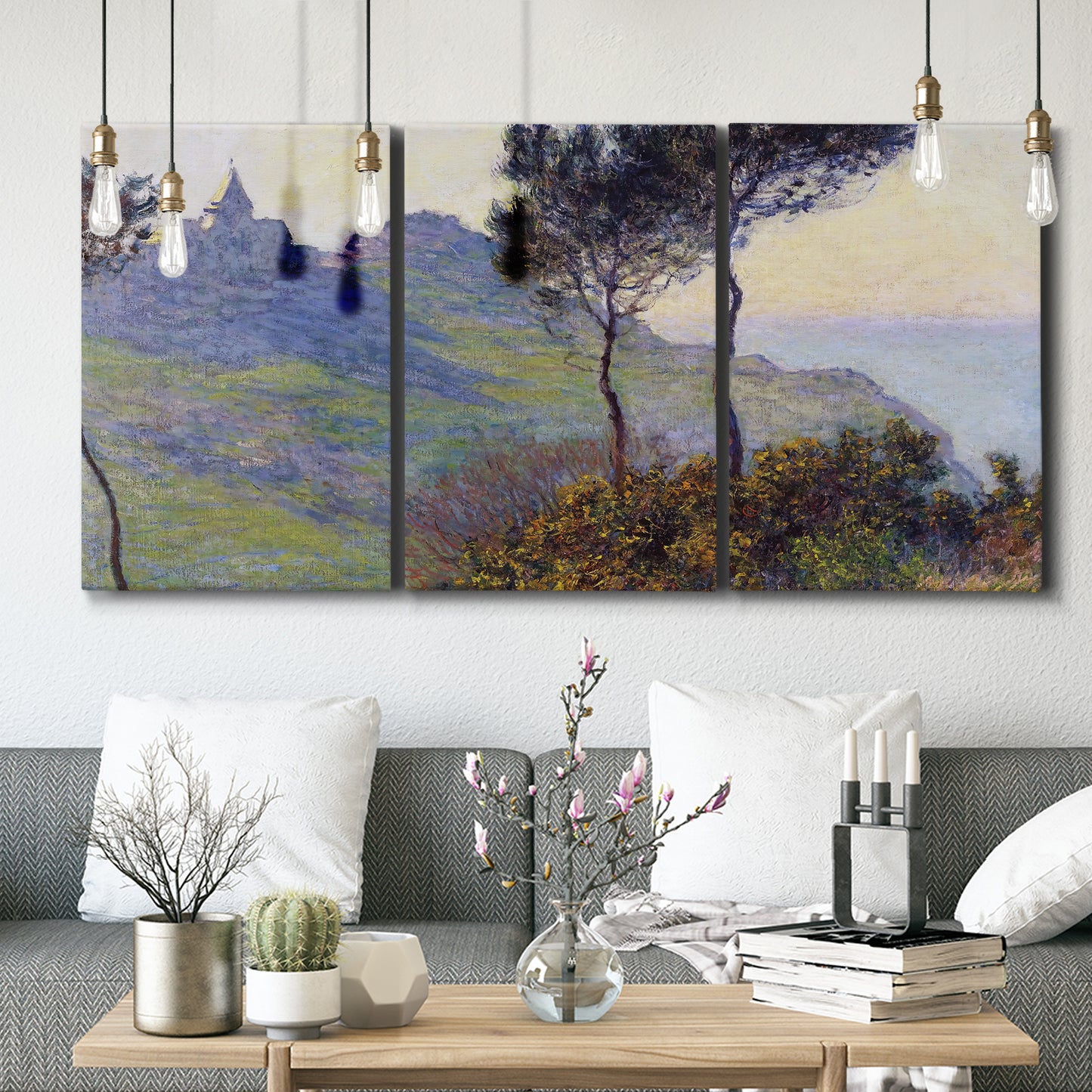 Three-panel canvas wall art featuring village church at sunset, displayed in a modern living room above seating.