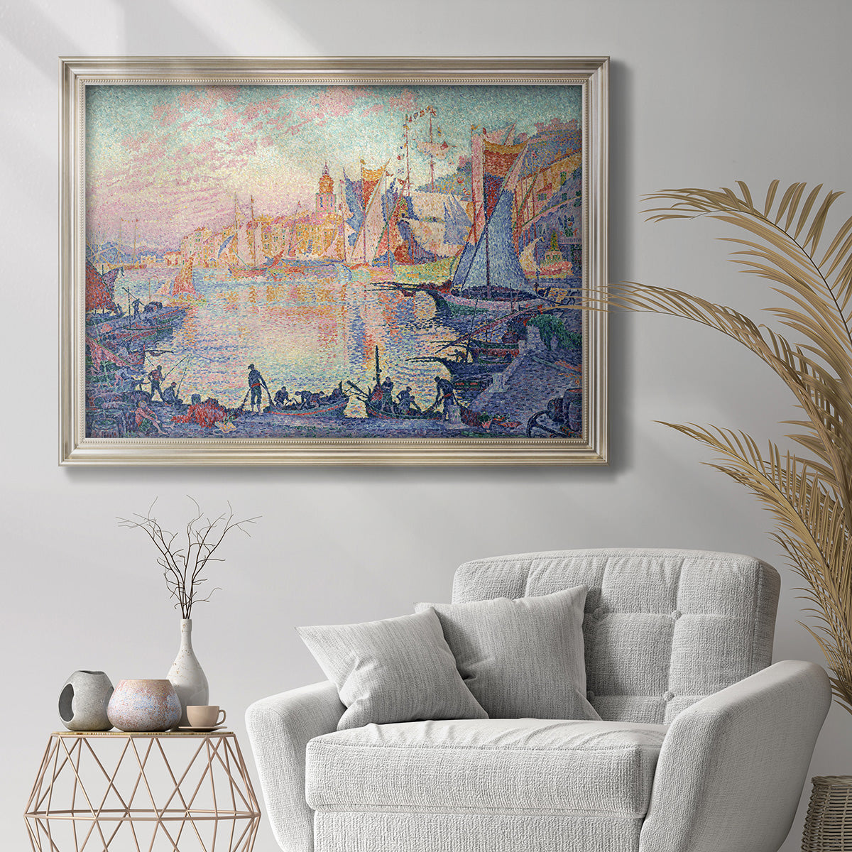 Impressionist Mediterranean harbor painting by Paul Signac in an ornate champagne frame displayed in a bright interior setting.