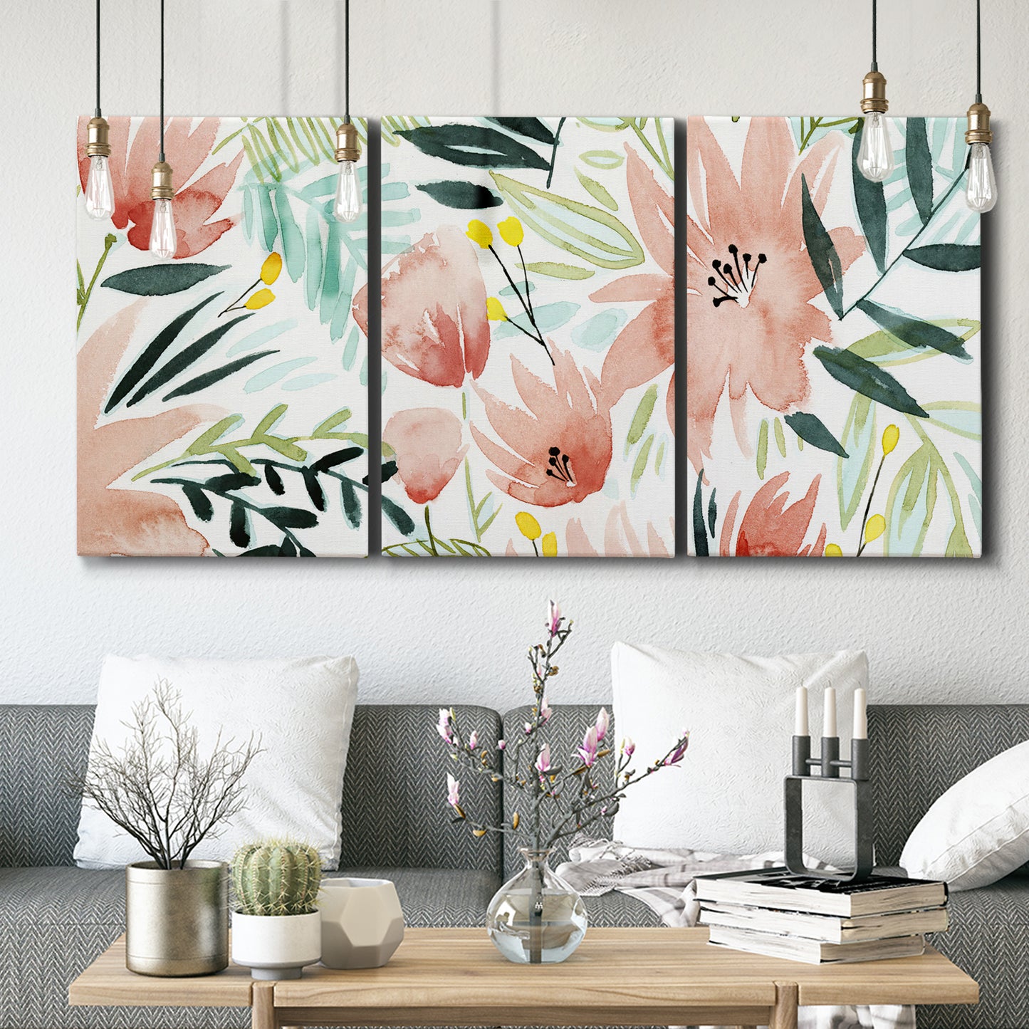 Three-panel canvas wall art featuring layered tropical plant collage, displayed in a modern living room above seating.