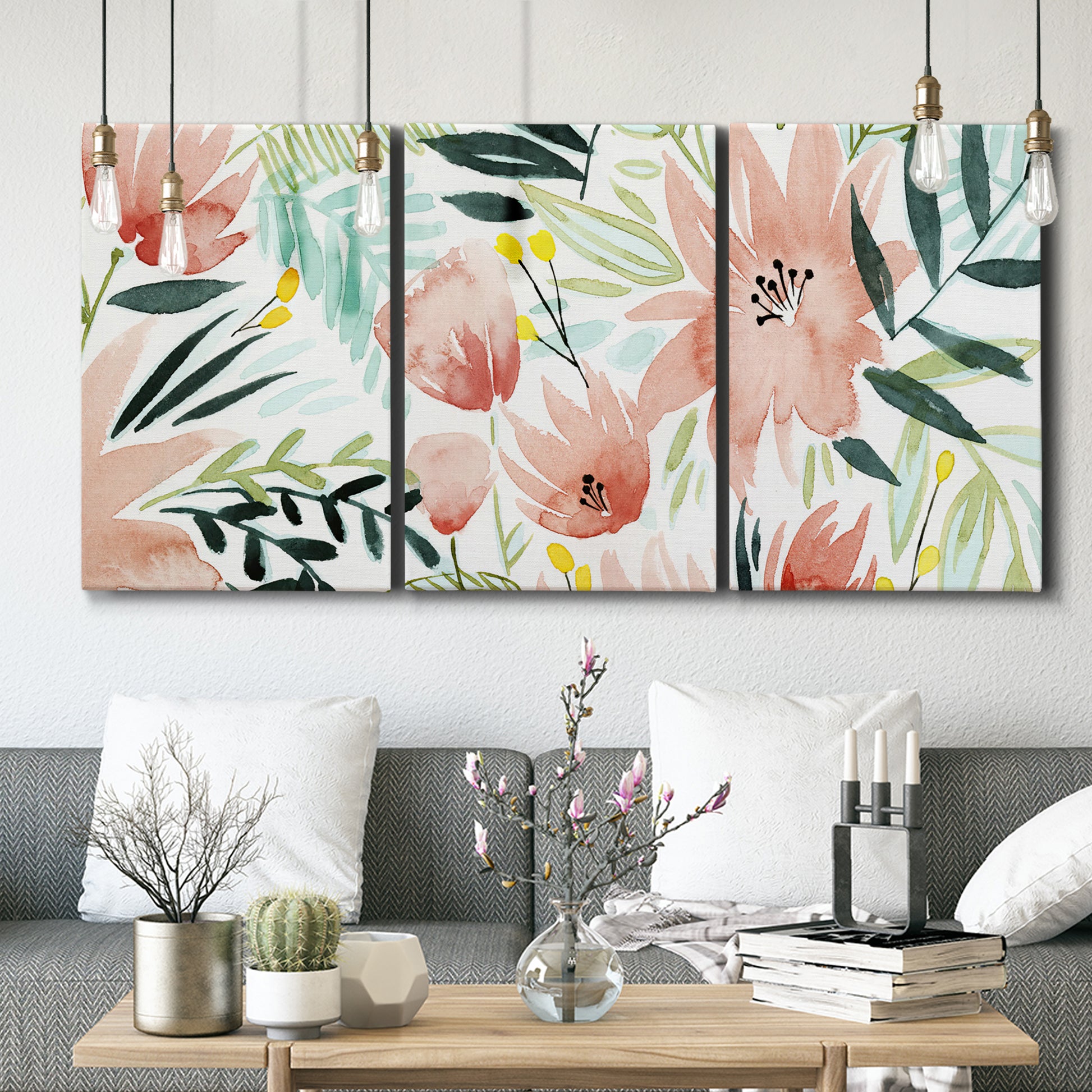 Three-panel canvas wall art featuring layered tropical plant collage, displayed in a modern living room above seating.
