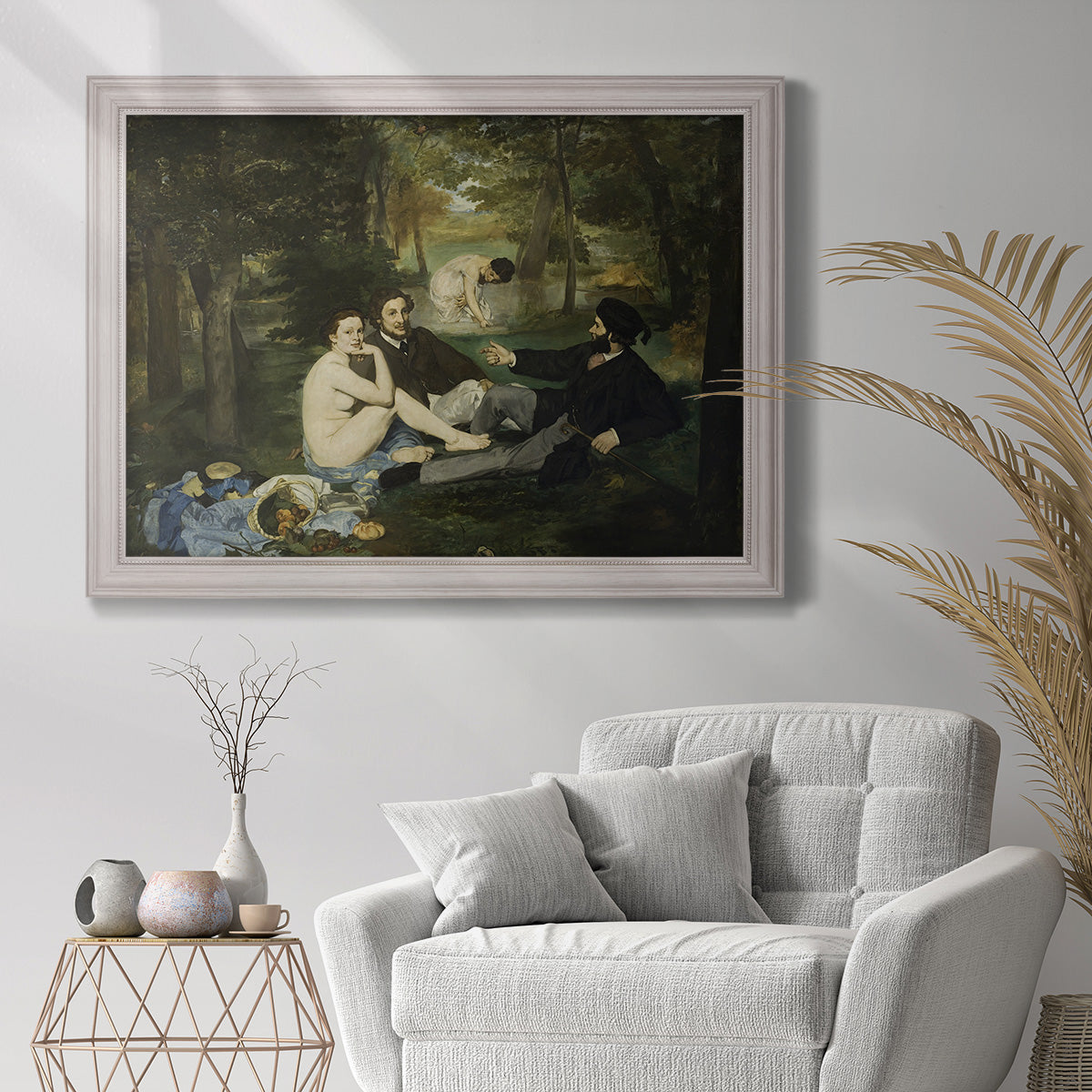 Groundbreaking impressionist picnic scene by Édouard Manet in an ornate weathered white frame displayed in a bright interior setting.