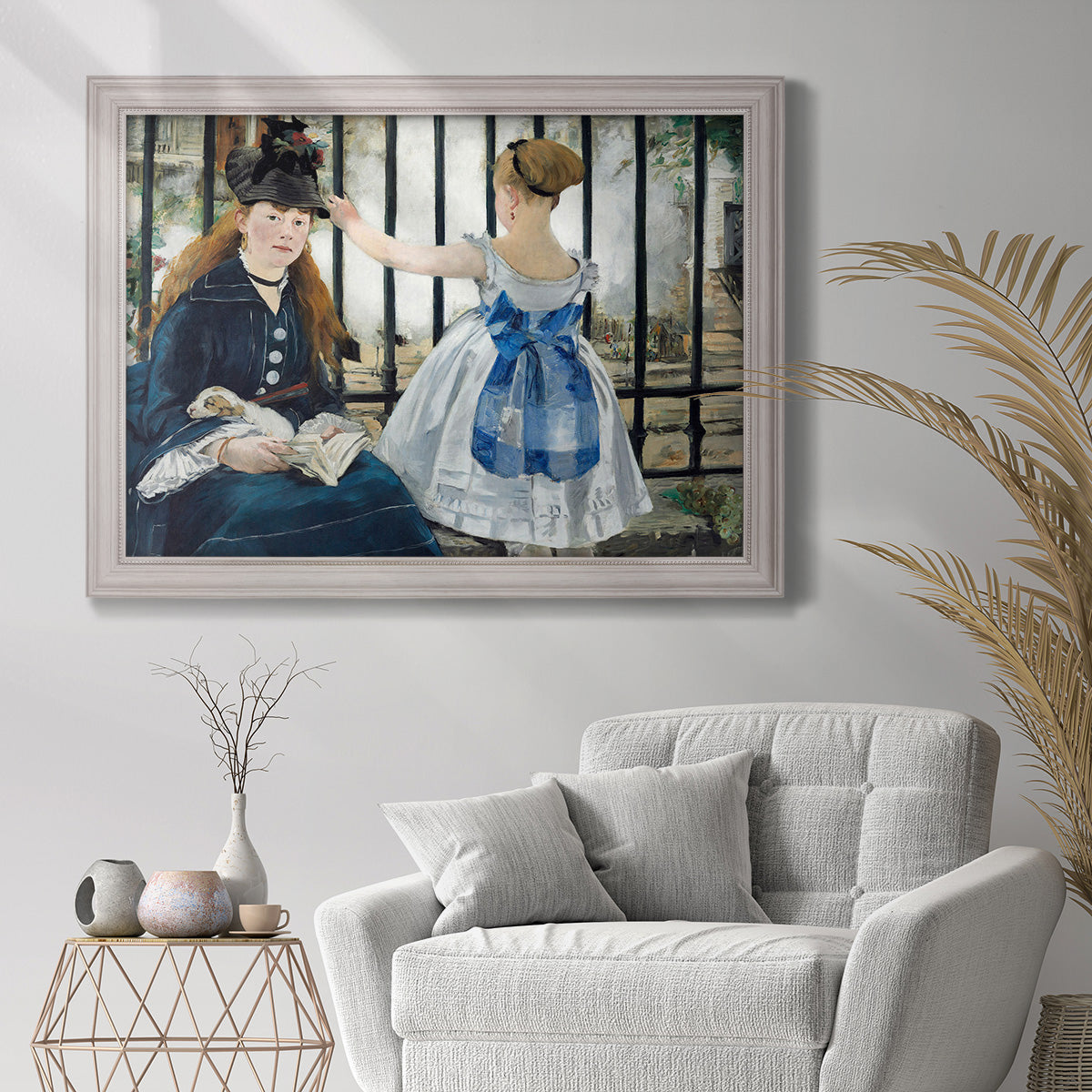 Impressionist urban scene near a railway by Édouard Manet in an ornate weathered white frame displayed in a bright interior setting.
