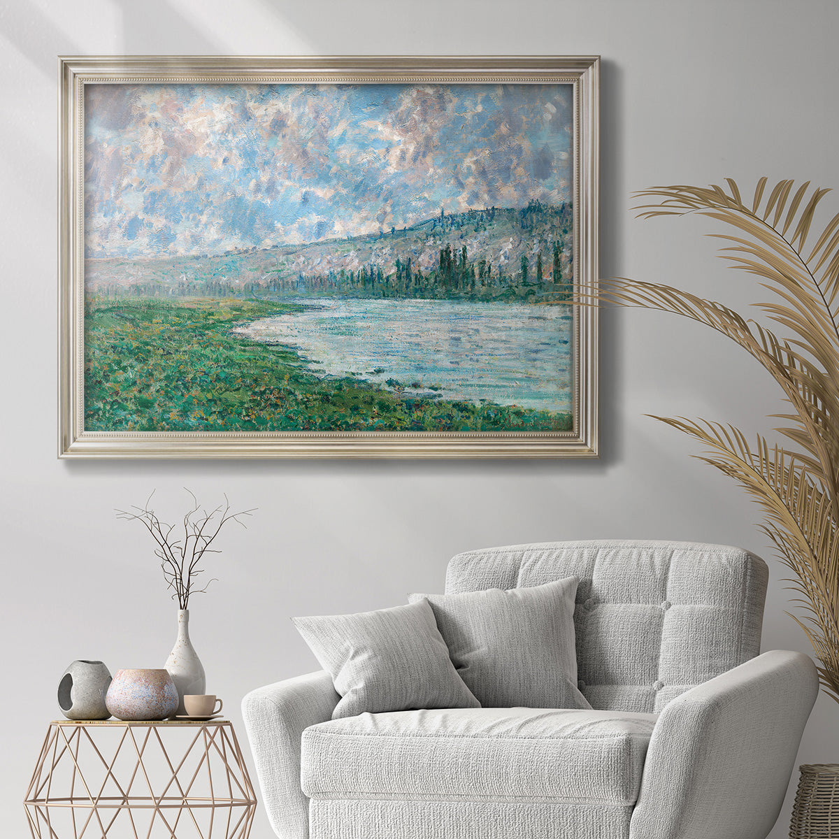 Impressionist river landscape at Vétheuil by Claude Monet in an ornate champagne frame displayed in a bright interior setting.