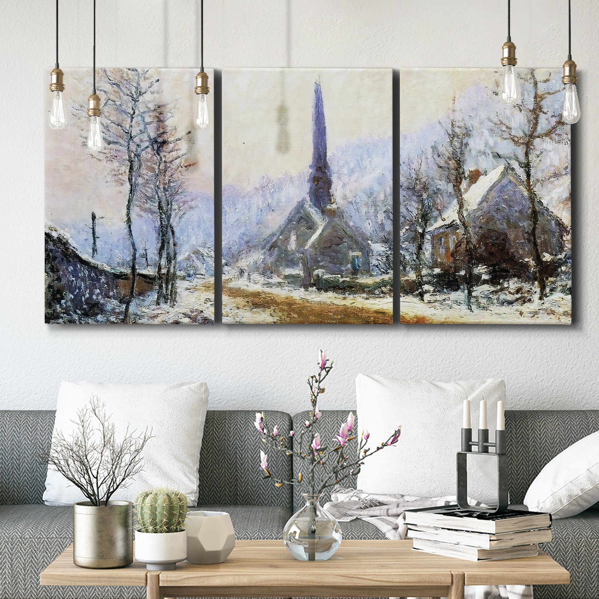 Three-panel canvas wall art featuring snow covered road leading to village, displayed in a modern living room above seating.