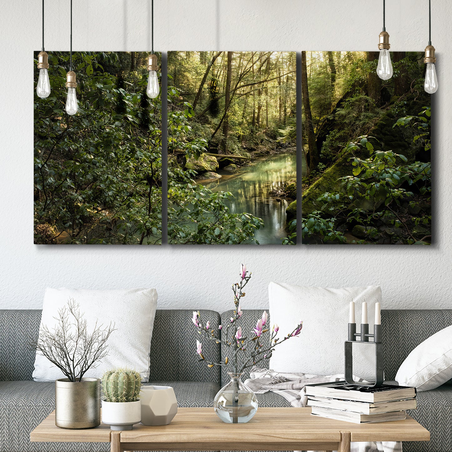 Three-panel canvas wall art featuring sun filtered woodland photograph, displayed in a modern living room above seating.