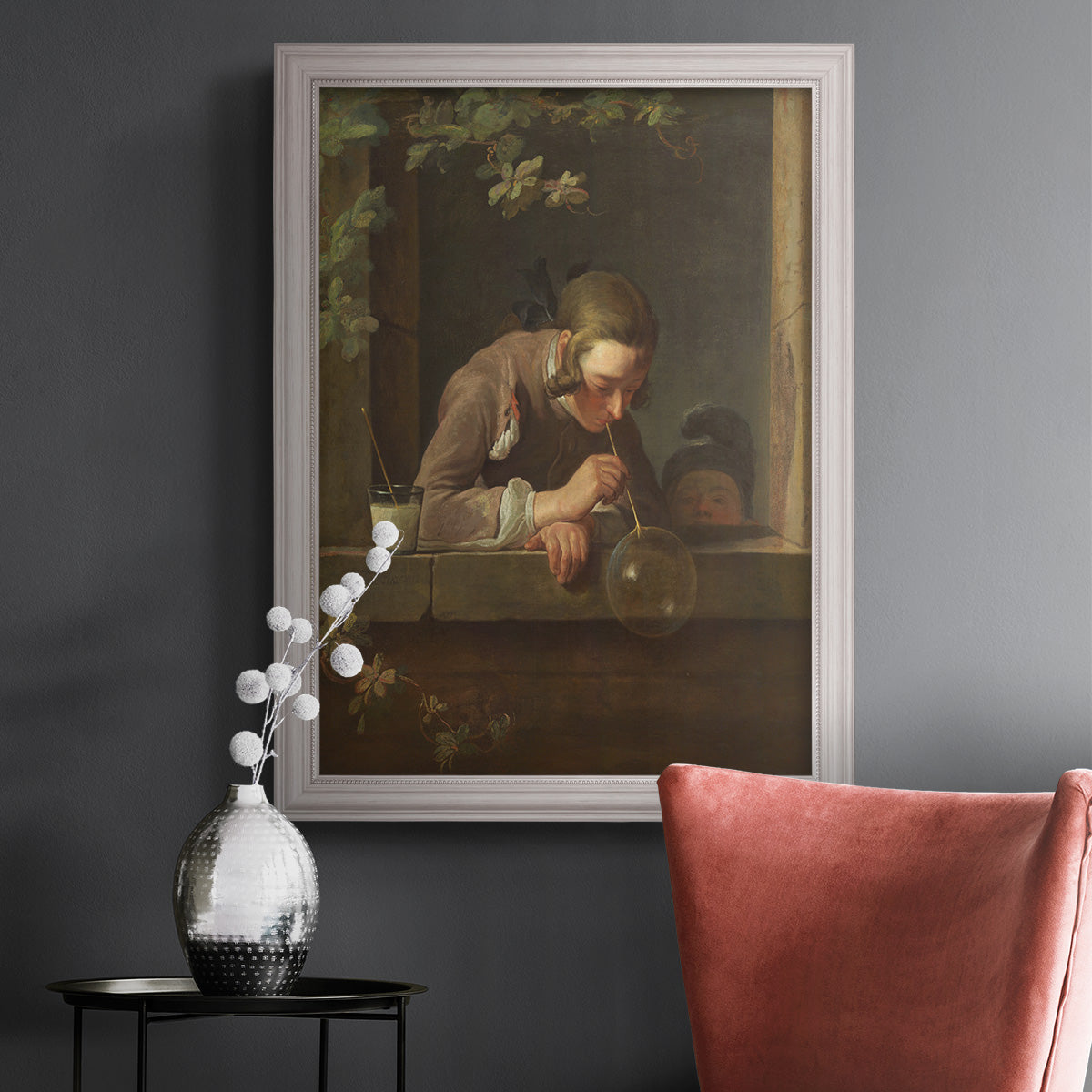 Classical genre painting of a child blowing soap bubbles by Jean-Siméon Chardin in an ornate weathered white frame displayed in a dark-toned interior setting.