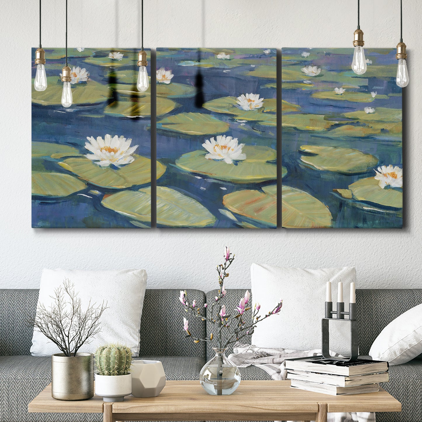 Three-panel canvas wall art featuring water lilies floating on pond, displayed in a modern living room above seating.