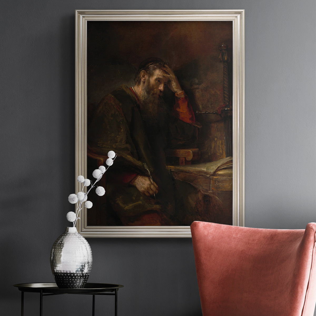 Classical religious portrait of Paul the Apostle by Rembrandt van Rijn in an ornate champagne frame displayed in a dark-toned interior setting.