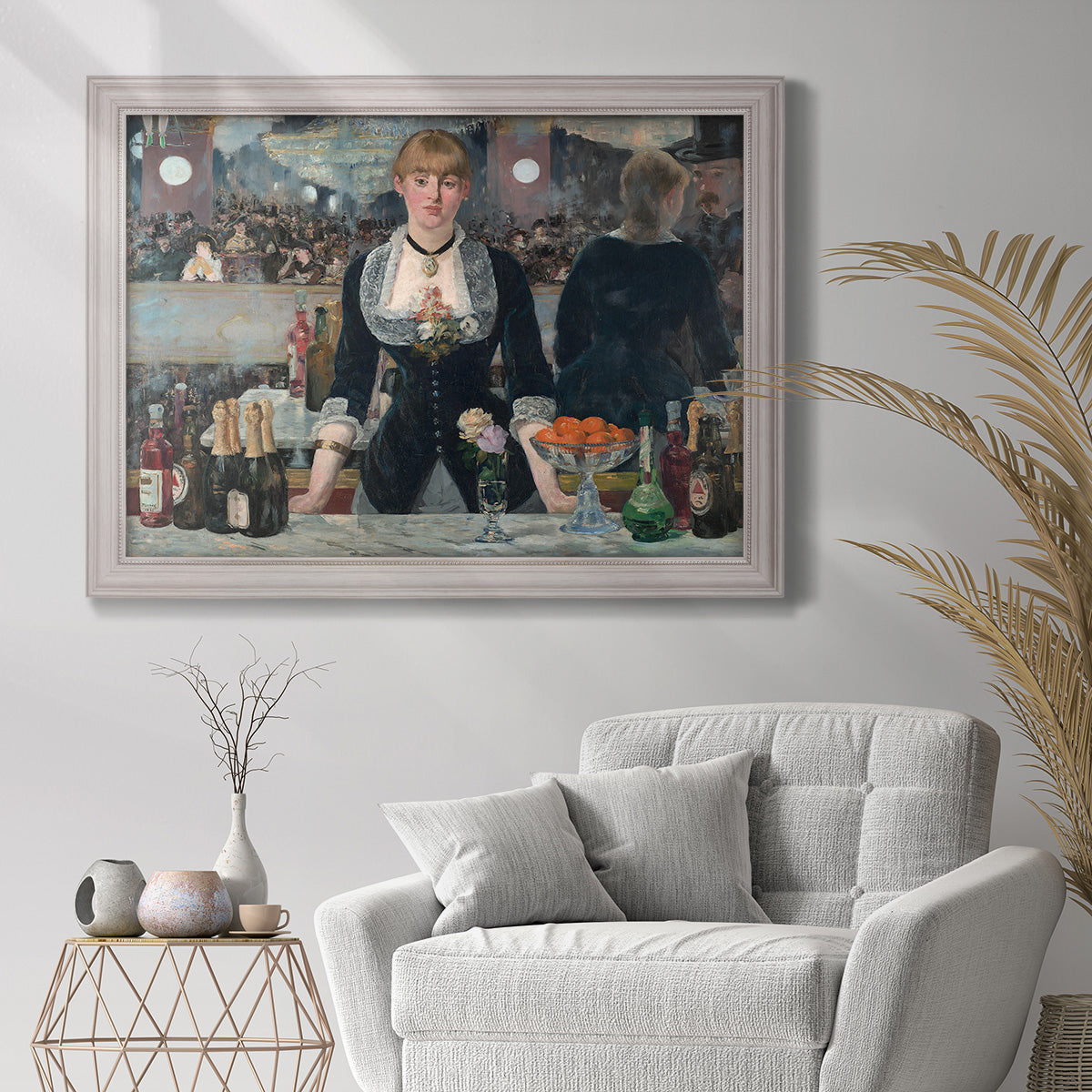 Iconic impressionist café bar scene by Édouard Manet in an ornate weathered white frame displayed in a bright interior setting.