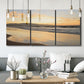 Three-panel canvas wall art featuring quiet tropical shoreline at low tide, displayed in a modern living room above seating.