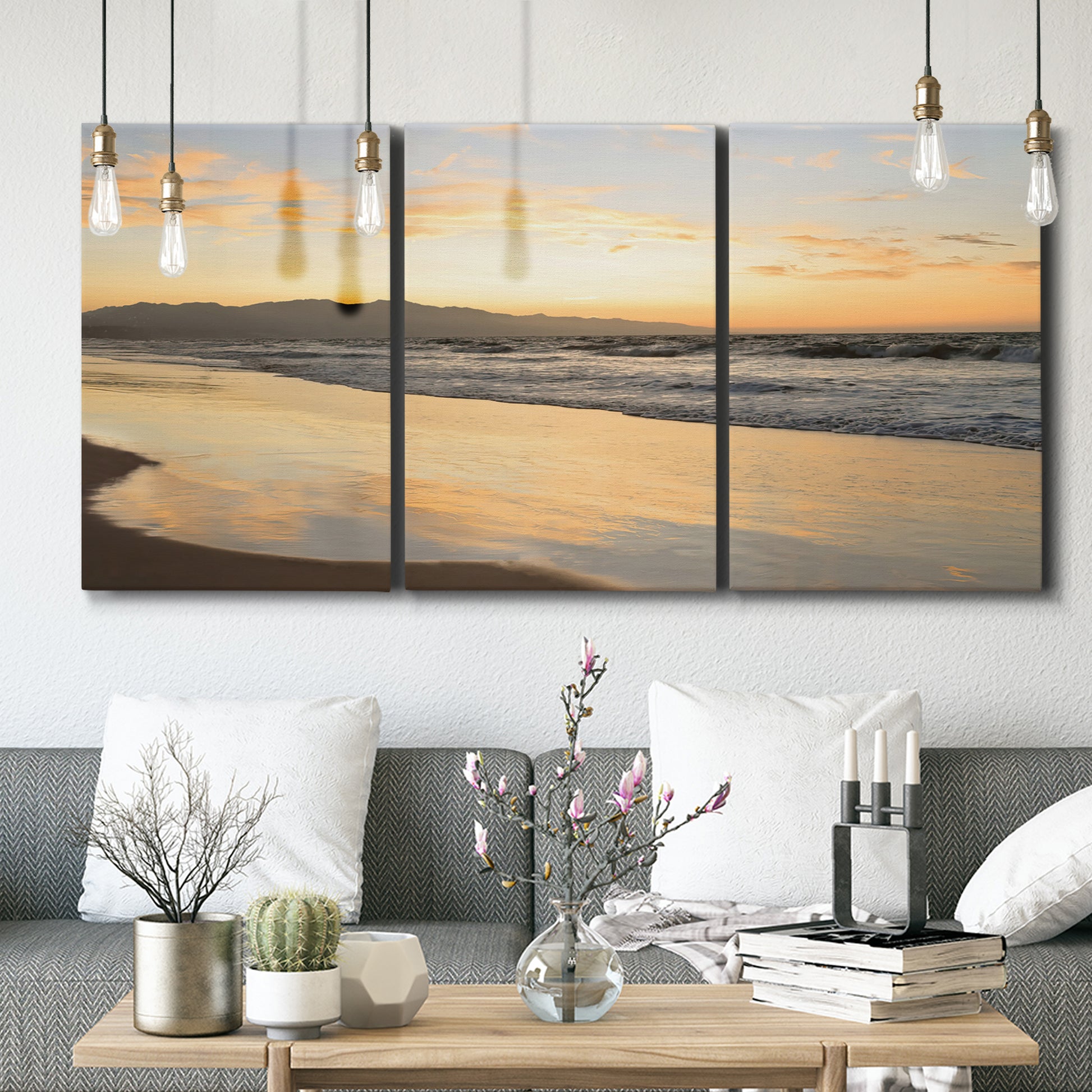 Three-panel canvas wall art featuring quiet tropical shoreline at low tide, displayed in a modern living room above seating.