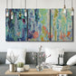 Three-panel canvas wall art featuring abstract rainfall with butterfly forms, displayed in a modern living room above seating.