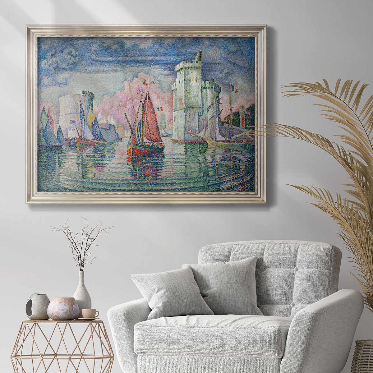 Impressionist harbor scene by Paul Signac in an ornate champagne frame displayed in a bright interior setting.