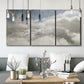 Three-panel canvas wall art featuring aerial landscape view photograph, displayed in a modern living room above seating.