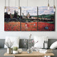 Three-panel canvas wall art featuring poppy field beside village landscape, displayed in a modern living room above seating.