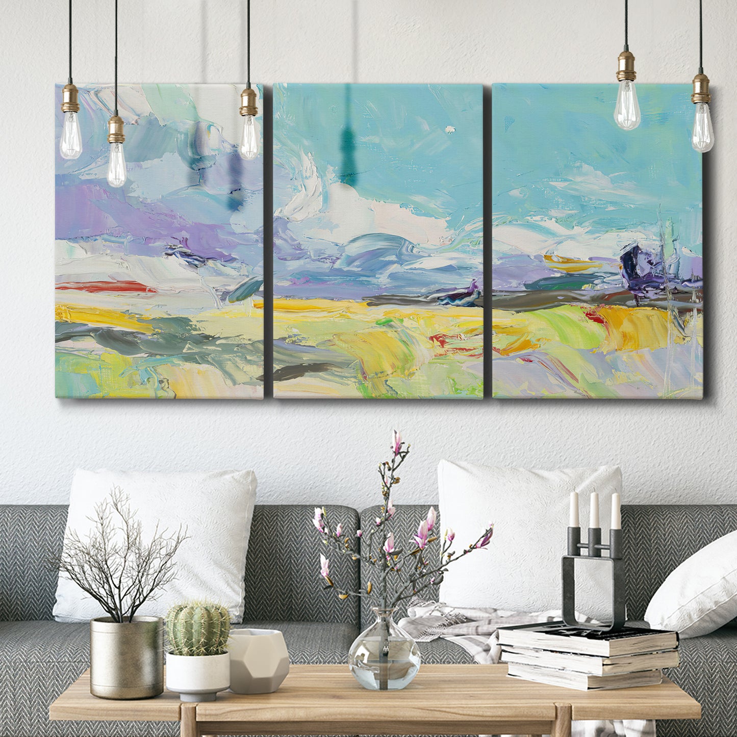 Three-panel canvas wall art featuring open landscape suggesting distant journey, displayed in a modern living room above seating.