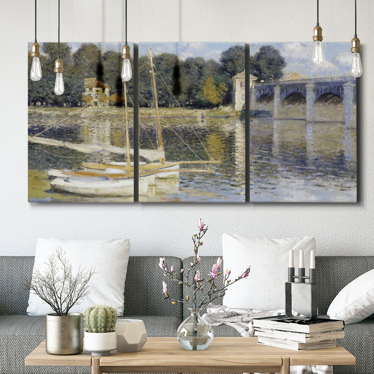 Three-panel canvas wall art featuring bridge crossing broad river, displayed in a modern living room above seating.