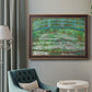 Impressionist garden scene with Japanese bridge and water lilies by Claude Monet in an ornate bronzed mahogany wood frame displayed in a bright interior setting.