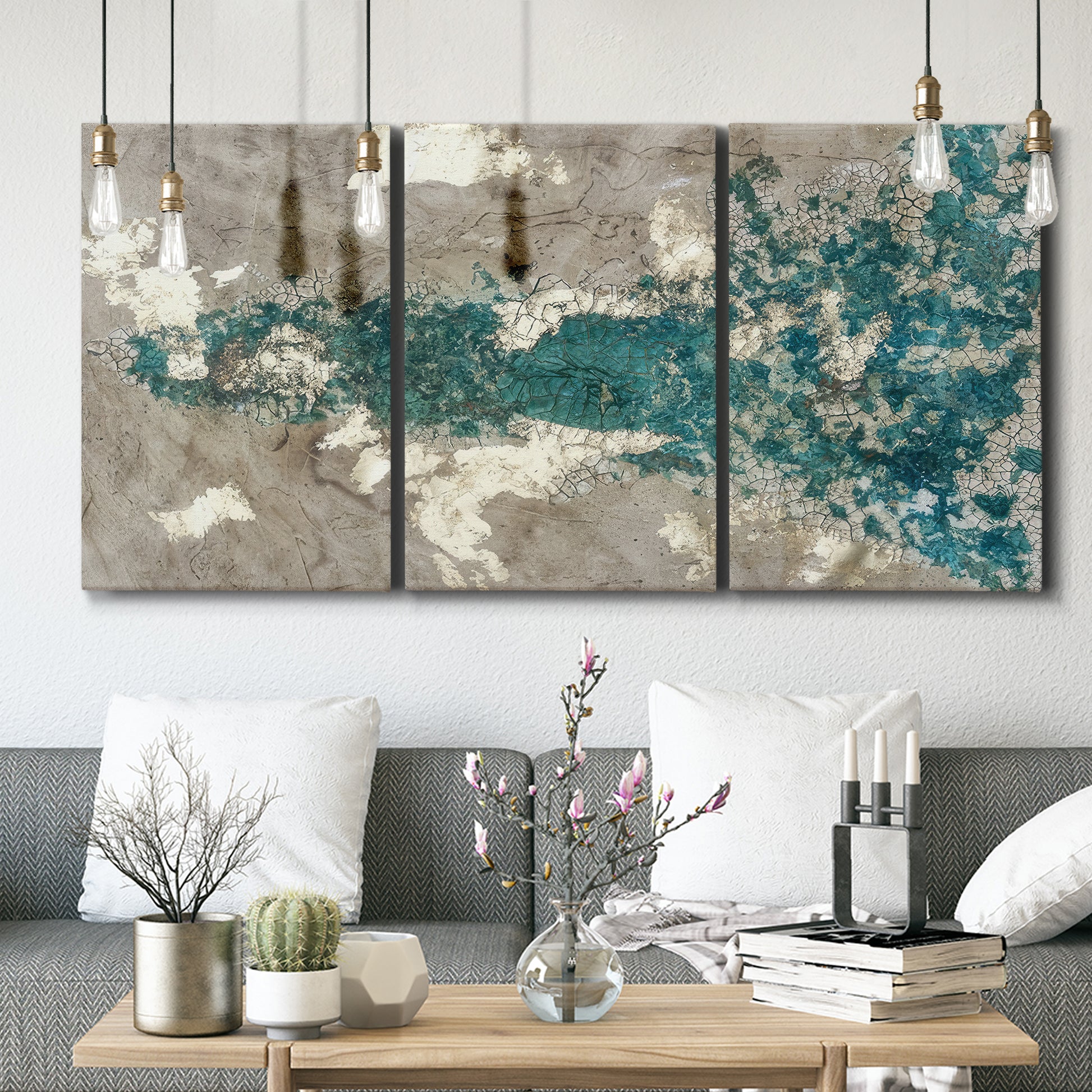 Three-panel canvas wall art featuring layered mineral abstract textures, displayed in a modern living room above seating.