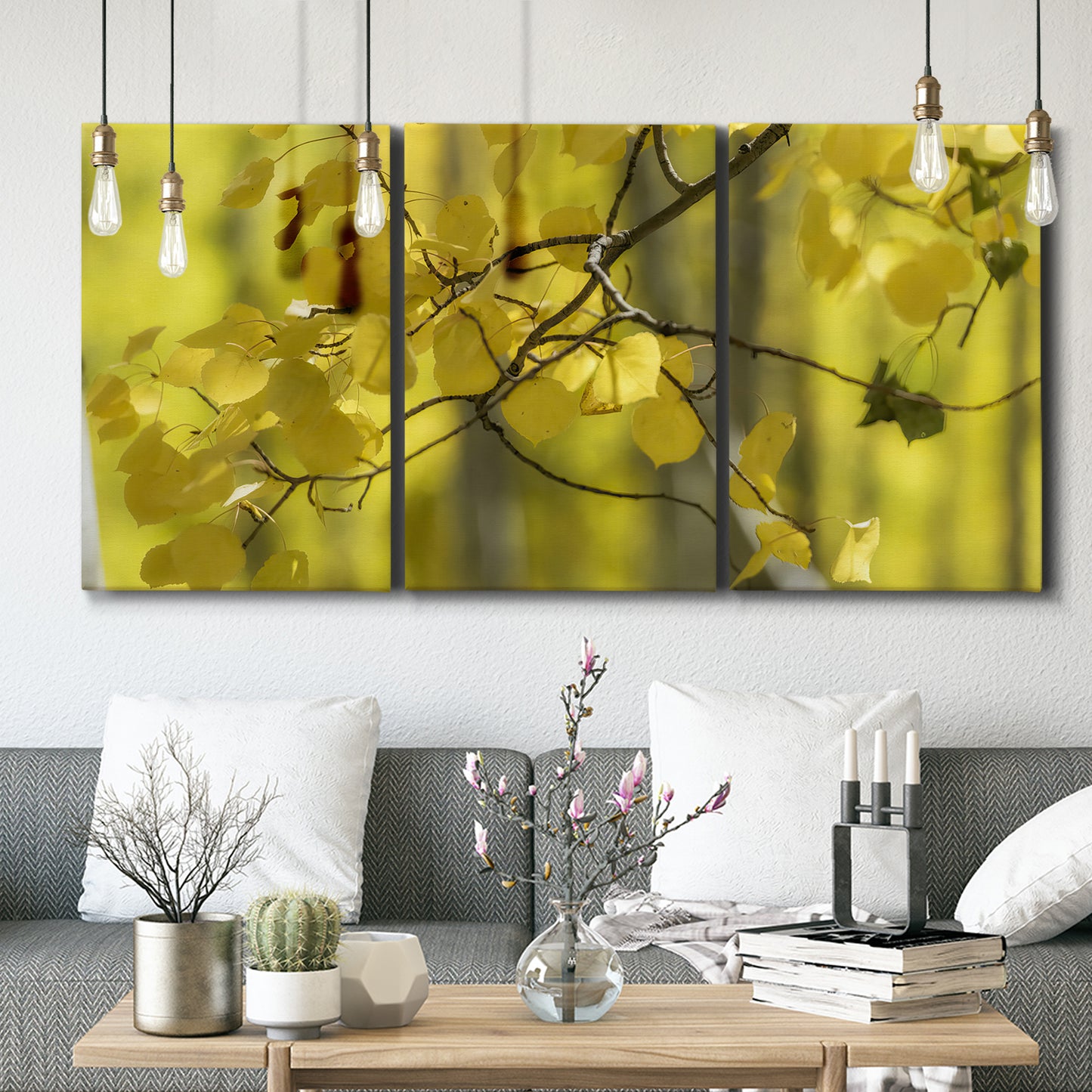 Three-panel canvas wall art featuring backlit aspen trees photograph, displayed in a modern living room above seating.