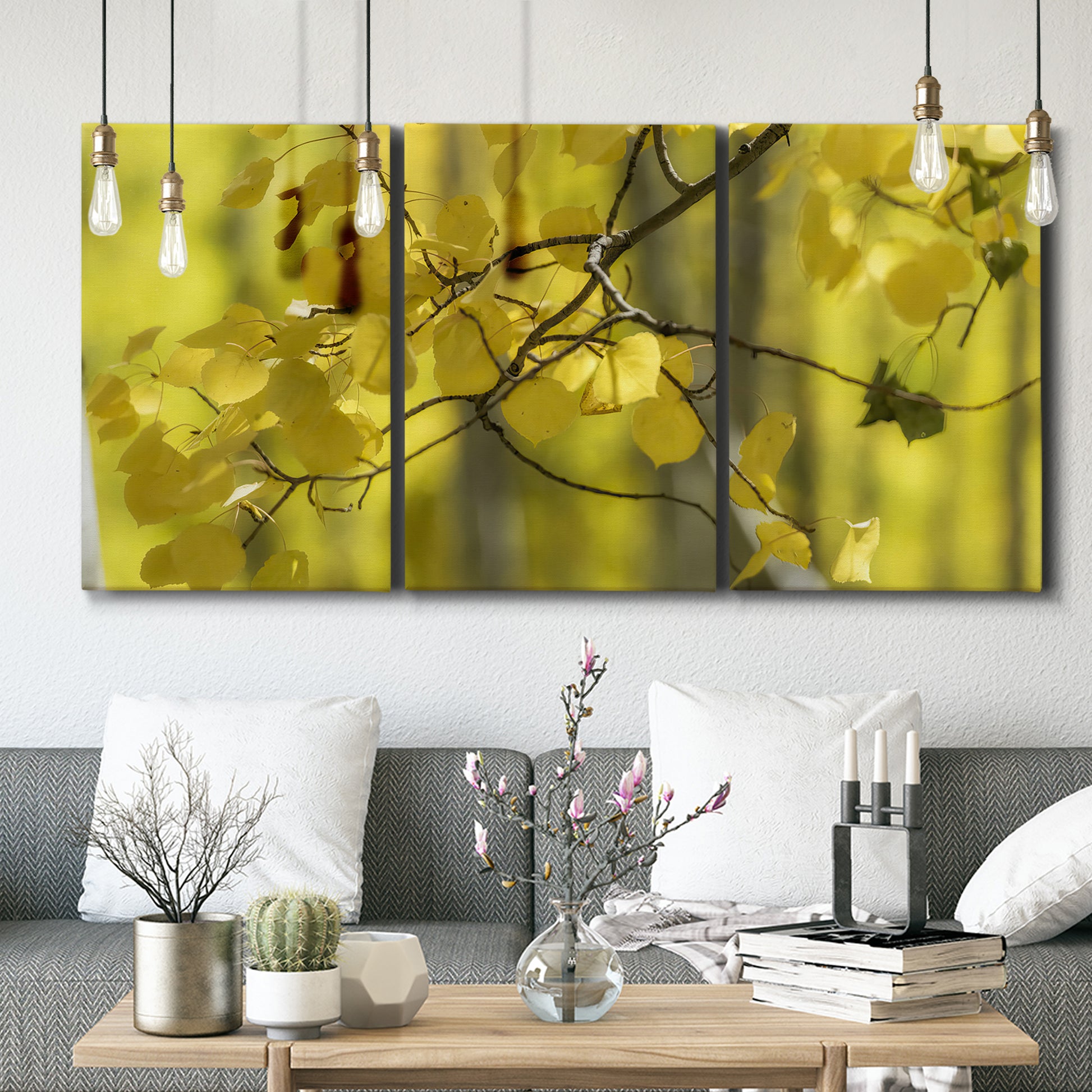 Three-panel canvas wall art featuring backlit aspen trees photograph, displayed in a modern living room above seating.