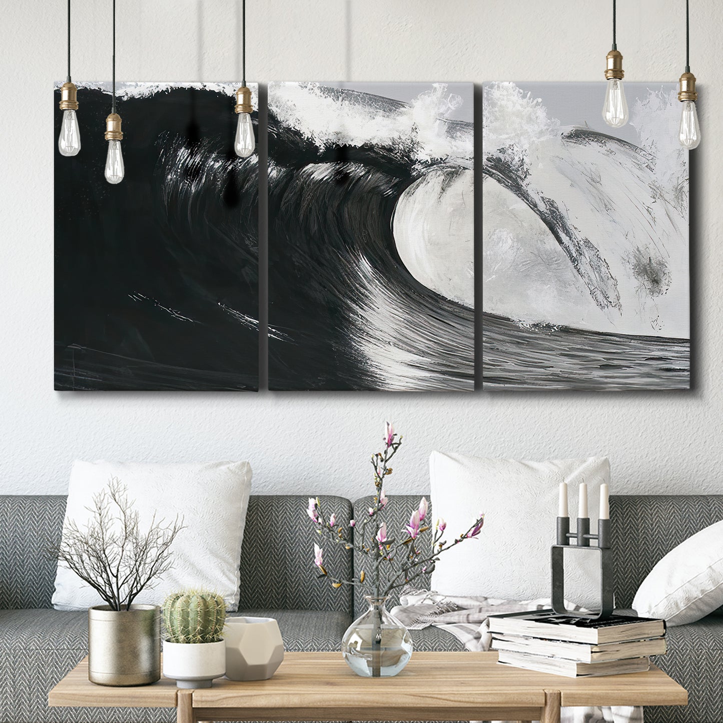 Three-panel canvas wall art featuring black and white crashing ocean waves, displayed in a modern living room above seating.