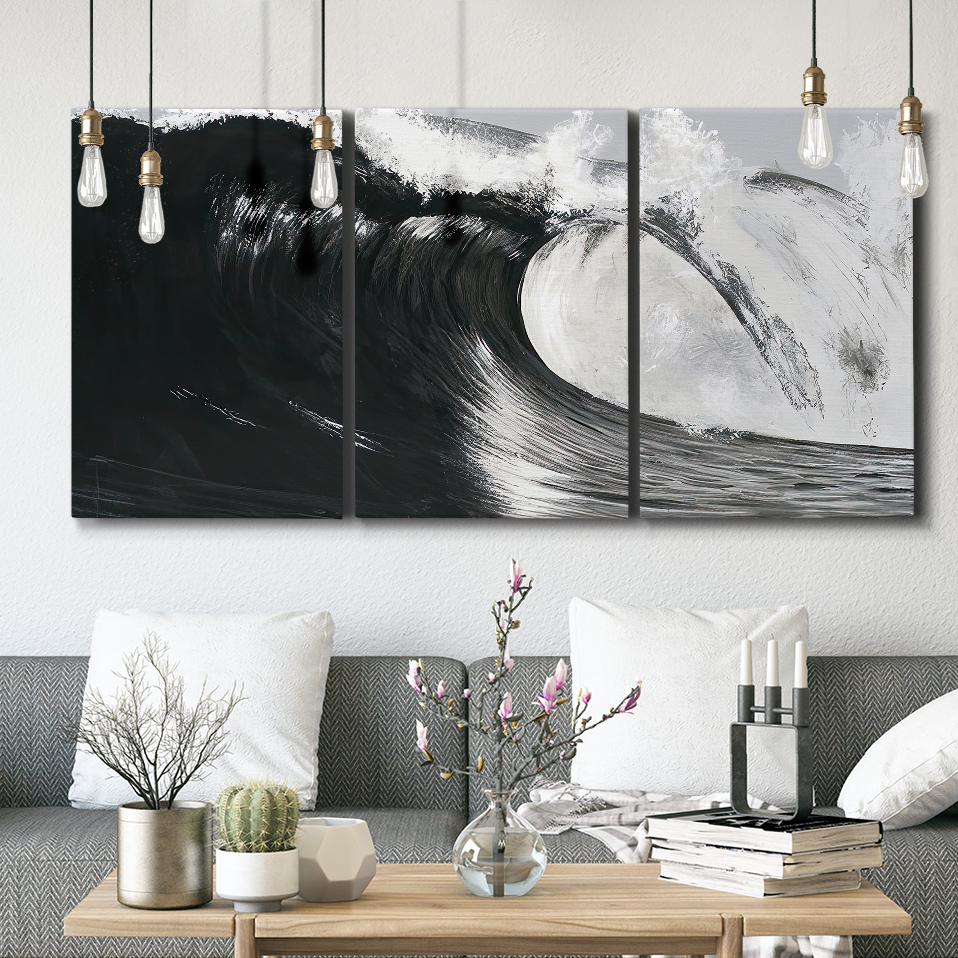 Three-panel canvas wall art featuring black and white crashing ocean waves, displayed in a modern living room above seating.