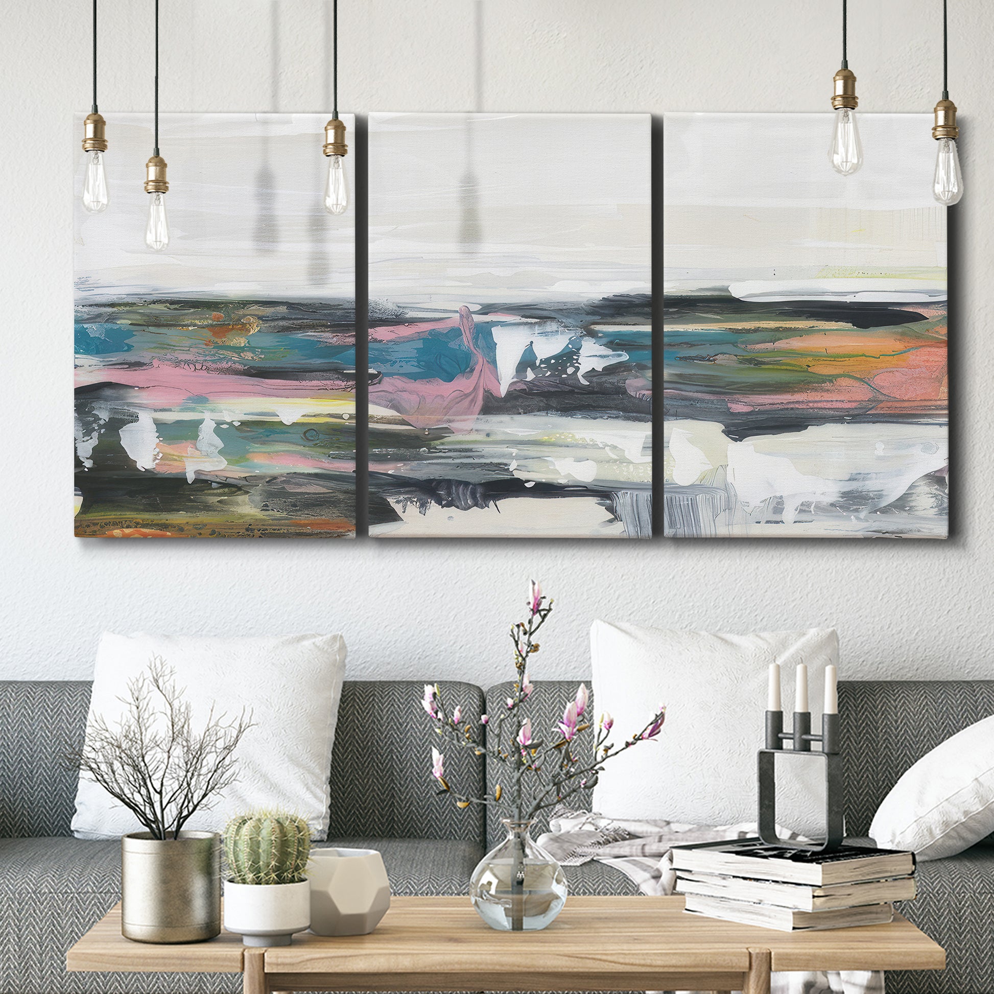 Three-panel canvas wall art featuring cheerful abstract coastal seascape, displayed in a modern living room above seating.