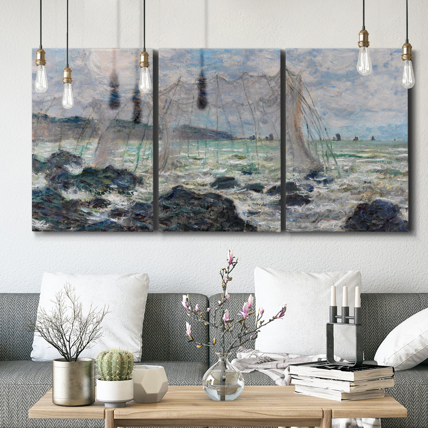 Three-panel canvas wall art featuring rough seas along rocky coast, displayed in a modern living room above seating.