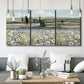 Three-panel canvas wall art featuring vintage poppy filled valley, displayed in a modern living room above seating.