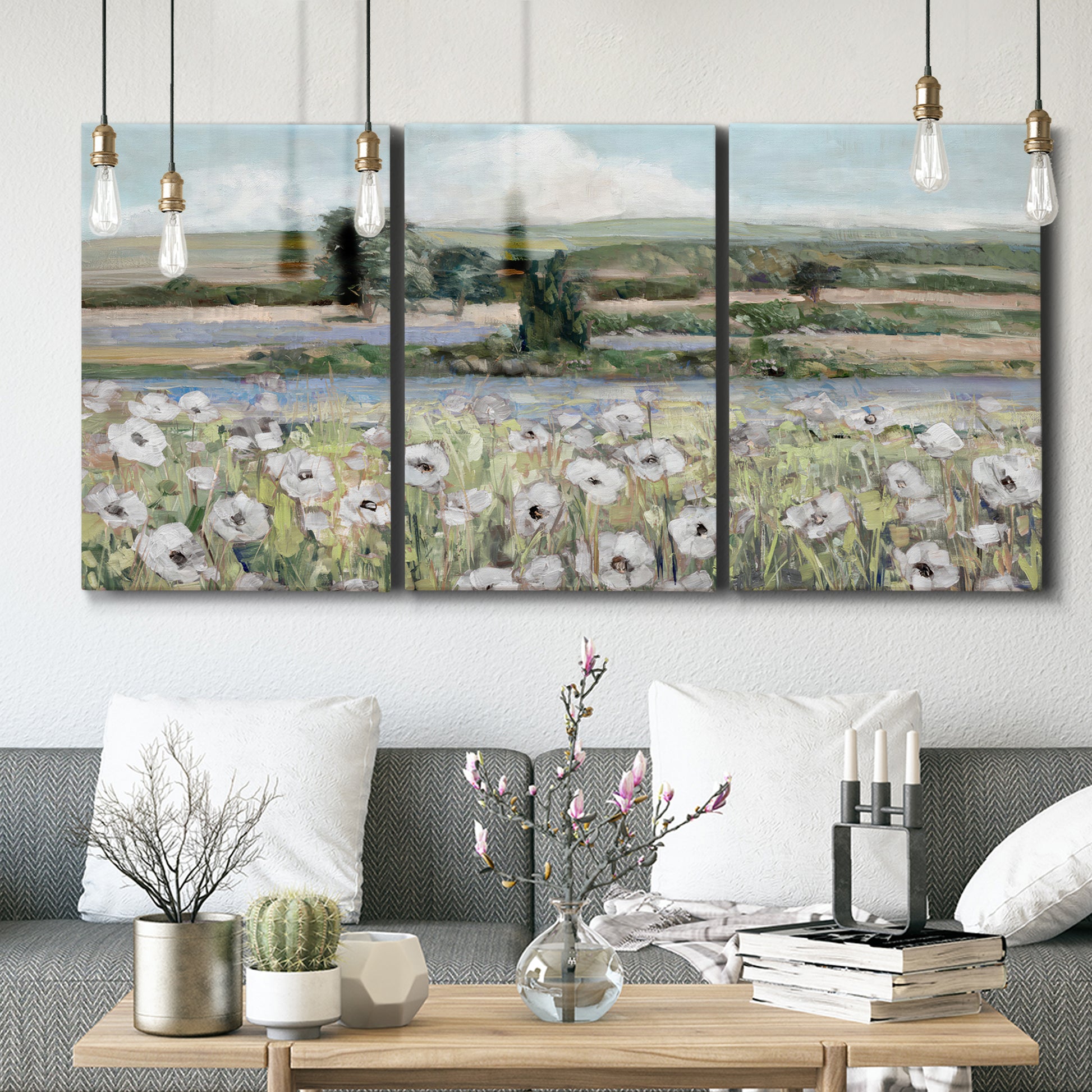 Three-panel canvas wall art featuring vintage poppy filled valley, displayed in a modern living room above seating.