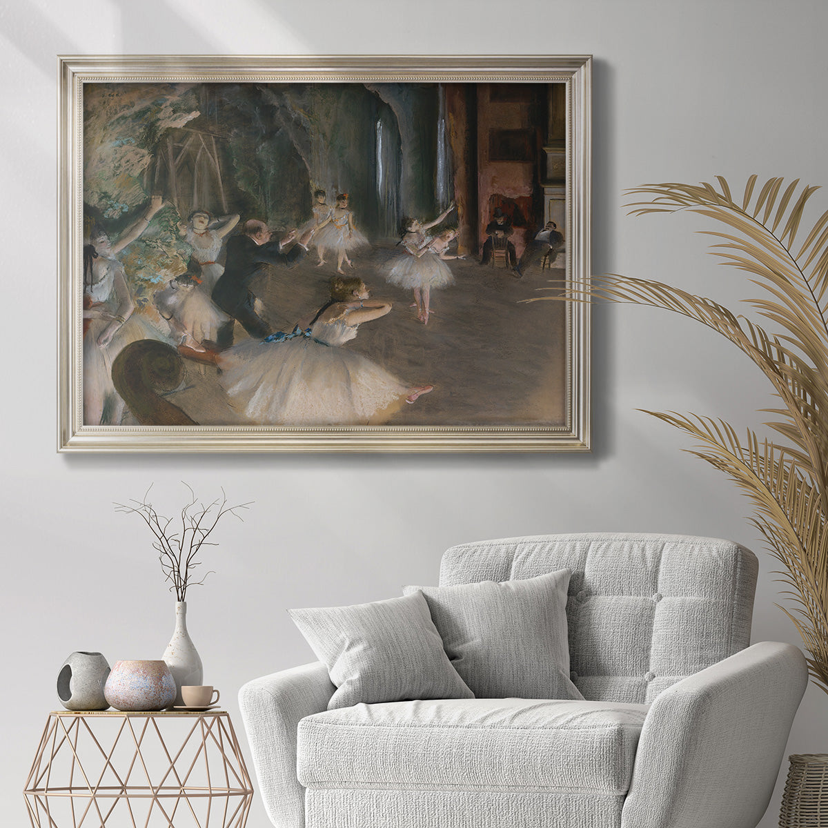 Impressionist backstage ballet scene by Edgar Degas in an ornate champagne frame displayed in a bright interior setting.