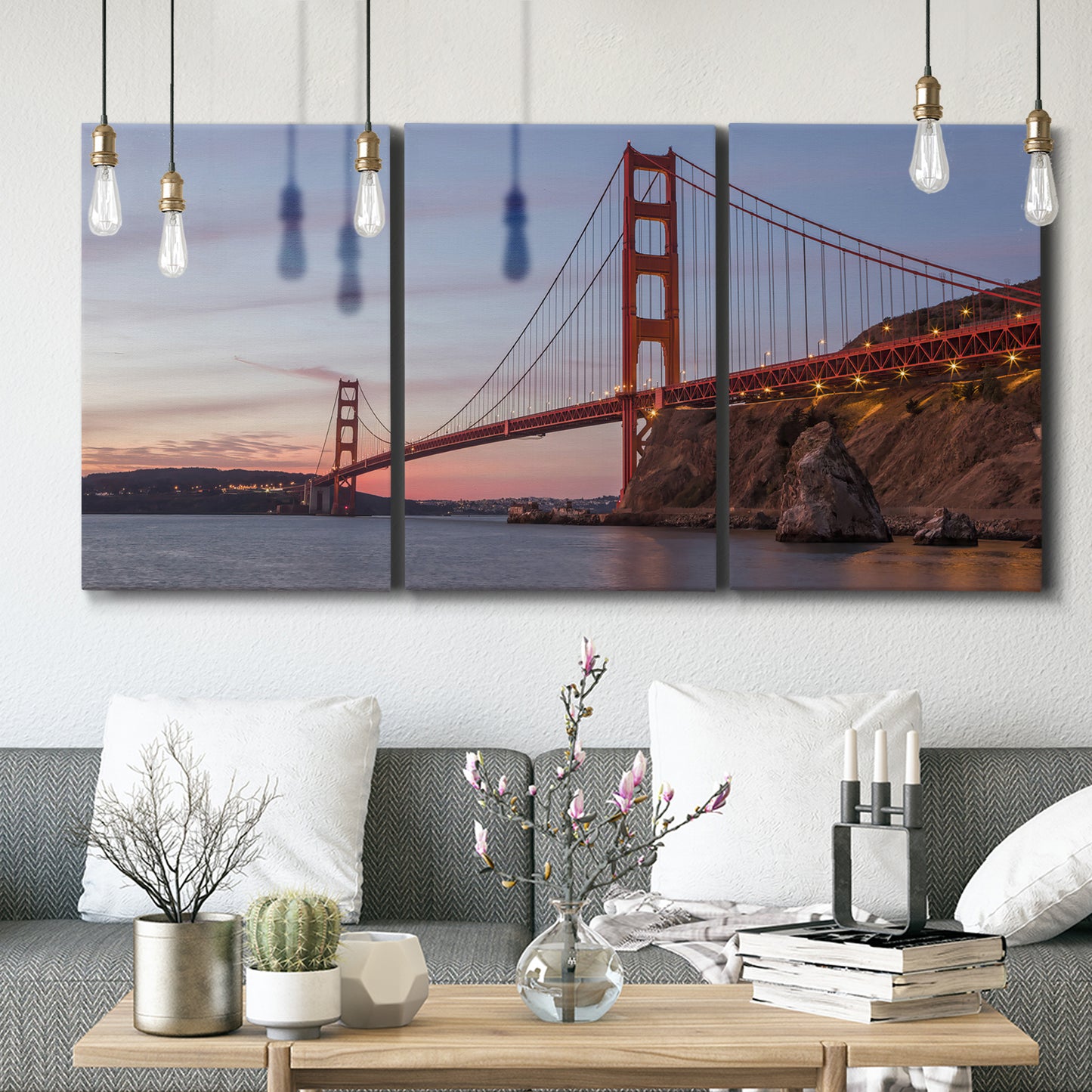 Three-panel canvas wall art featuring golden gate bridge spanning bay, displayed in a modern living room above seating.